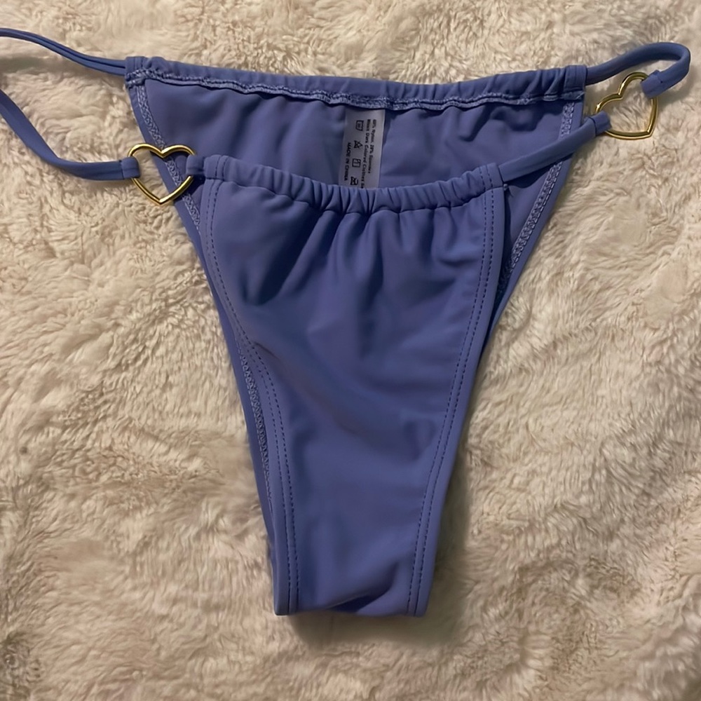 Purple bathing suit bottoms with gold heart
